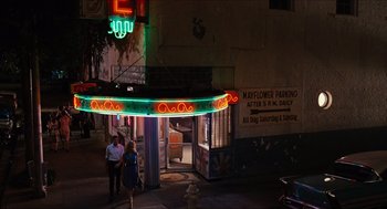 Movie still from “The Help” (2011), directed by Tate Taylor – Two people walking on the sidewalk in front of a building; Extreme Wide shot, High angle