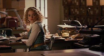 Movie still from “The Help” (2011), directed by Tate Taylor – A woman sitting at a table in a room; Medium shot, Over the shoulder angle
