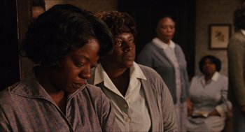 Movie still from “The Help” (2011), directed by Tate Taylor – A group of women standing next to each other in a room; Medium shot, Low angle