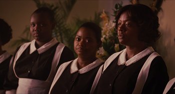 Movie still from “The Help” (2011), directed by Tate Taylor – A group of women standing next to each other in front of flowers; Medium shot, Low angle