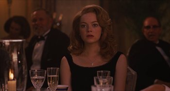 Movie still from “The Help” (2011), directed by Tate Taylor – A woman sitting in front of a table with glasses of wine; Close Up shot, Over the shoulder angle