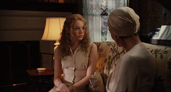Movie still from “The Help” (2011), directed by Tate Taylor – A woman sitting on a chair talking to another woman; Medium shot, Over the shoulder angle