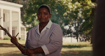 Movie still from “The Help” (2011), directed by Tate Taylor – An older woman standing in front of a tree; Medium shot, Over the shoulder angle