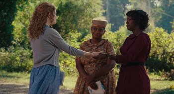 Movie still from “The Help” (2011), directed by Tate Taylor – A group of women standing next to each other; Medium shot, Over the shoulder angle