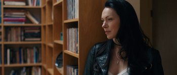 Movie still from “The Hero” (2017), directed by Brett Haley – A woman in a leather jacket leaning against a book case; Close Up shot, Over the shoulder angle