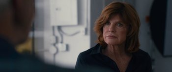 Movie still from “The Hero” (2017), directed by Brett Haley – An older woman with red hair looking at the camera; Close Up shot, Over the shoulder angle