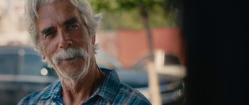 Movie still from “The Hero” (2017), directed by Brett Haley – An older man with a gray beard is looking at the camera; Close Up shot, Over the shoulder angle