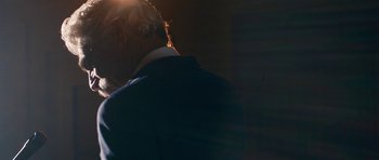 Movie still from “The Hero” (2017), directed by Brett Haley – A man in a blue suit standing in the sunlight; Close Up shot, Low angle