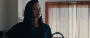 Movie still from “The Hero” (2017), directed by Brett Haley – A woman with long black hair standing in front of a window; Close Up shot, Over the shoulder angle