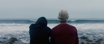 Movie still from “The Hero” (2017), directed by Brett Haley – A man and a woman looking out at the ocean; Medium shot, Over the shoulder angle