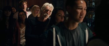 Movie still from “The Hero” (2017), directed by Brett Haley – A man and two women are sitting in a room; Medium shot, Over the shoulder angle