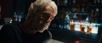 Movie still from “The Hero” (2017), directed by Brett Haley – An older man with white hair and white beard; Close Up shot, Over the shoulder angle