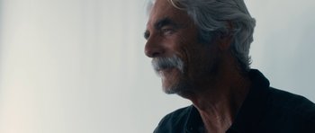 Movie still from “The Hero” (2017), directed by Brett Haley – An older man with white hair and a mustache; Close Up shot, Over the shoulder angle