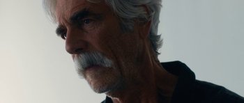 Movie still from “The Hero” (2017), directed by Brett Haley – An older man with white hair and a gray beard; Close Up shot, Over the shoulder angle