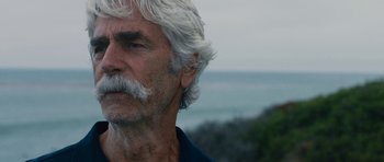 Movie still from “The Hero” (2017), directed by Brett Haley – An older man with white hair and a mustache; Close Up shot, Over the shoulder angle