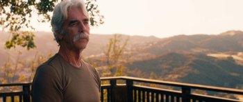Movie still from “The Hero” (2017), directed by Brett Haley – An older man standing on a deck with a mountain view; Close Up shot, Over the shoulder angle