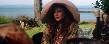 Movie still from “Practical Magic” (1998), directed by Griffin Dunne – A woman with a hat sitting on a chair; Close Up shot, Over the shoulder angle