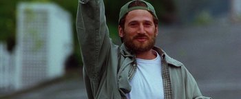 Movie still from “Practical Magic” (1998), directed by Griffin Dunne – A man with a beard wearing a baseball cap; Close Up shot, Low angle