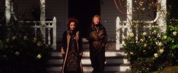 Movie still from “Practical Magic” (1998), directed by Griffin Dunne – Two women standing on the steps of a house; Medium shot, Low angle