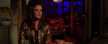 Movie still from “Practical Magic” (1998), directed by Griffin Dunne – A woman sitting at a table in front of a window; Medium shot, Over the shoulder angle