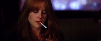 Movie still from “Practical Magic” (1998), directed by Griffin Dunne – A woman is smoking a cigarette in a dark room; Close Up shot, Low angle