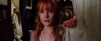Movie still from “Practical Magic” (1998), directed by Griffin Dunne – A young girl with red hair and blue eyes; Close Up shot, Low angle