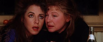 Movie still from “Practical Magic” (1998), directed by Griffin Dunne – A woman and a woman with their arms around each other; Close Up shot, High angle