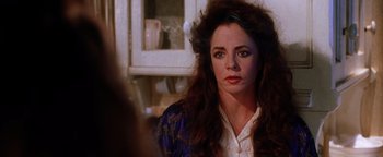 Movie still from “Practical Magic” (1998), directed by Griffin Dunne – A person sitting in a room; Close Up shot, Over the shoulder angle