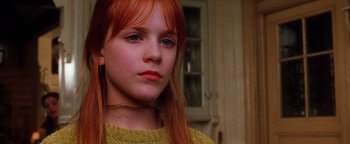 Movie still from “Practical Magic” (1998), directed by Griffin Dunne – A girl with red hair and a yellow sweater looking to her left; Close Up shot, Low angle