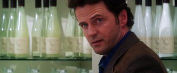 Movie still from “Practical Magic” (1998), directed by Griffin Dunne – A person wearing a suit and tie; Close Up shot, Over the shoulder angle