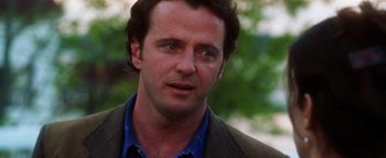 Movie still from “Practical Magic” (1998), directed by Griffin Dunne – A person wearing a jacket; Close Up shot, Over the shoulder angle