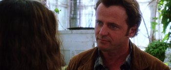 Movie still from “Practical Magic” (1998), directed by Griffin Dunne – A person wearing a brown jacket; Close Up shot, Over the shoulder angle