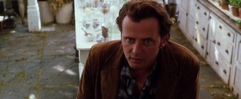 Movie still from “Practical Magic” (1998), directed by Griffin Dunne – A person wearing a brown jacket; Close Up shot, Over the shoulder angle