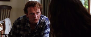 Movie still from “Practical Magic” (1998), directed by Griffin Dunne – A man sitting in front of a woman in front of a window; Close Up shot, Over the shoulder angle