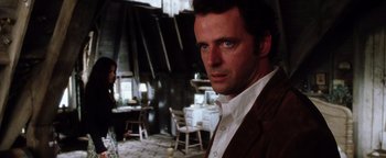 Movie still from “Practical Magic” (1998), directed by Griffin Dunne – A man standing in front of a woman in a room; Close Up shot, Over the shoulder angle