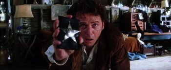 Movie still from “Practical Magic” (1998), directed by Griffin Dunne – A man is holding a box with a star on it; Close Up shot, Low angle