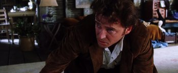 Movie still from “Practical Magic” (1998), directed by Griffin Dunne – A person wearing a suit and tie; Close Up shot, Over the shoulder angle