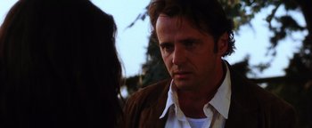 Movie still from “Practical Magic” (1998), directed by Griffin Dunne – A person wearing a brown jacket; Close Up shot, Over the shoulder angle