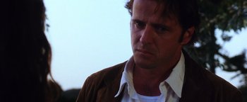 Movie still from “Practical Magic” (1998), directed by Griffin Dunne – A person wearing a shirt and jacket; Close Up shot, Low angle