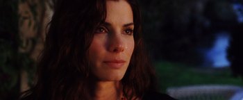Movie still from “Practical Magic” (1998), directed by Griffin Dunne – A woman's face in the dark; Close Up shot, Over the shoulder angle