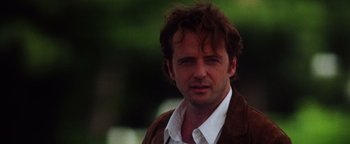 Movie still from “Practical Magic” (1998), directed by Griffin Dunne – A person wearing a brown jacket; Close Up shot, Over the shoulder angle