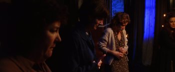 Movie still from “Practical Magic” (1998), directed by Griffin Dunne – A group of women standing next to each other in a room; Medium shot, Over the shoulder angle