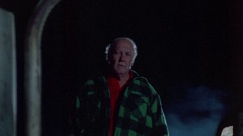 Movie still from “The Hills Have Eyes” (1977), directed by Wes Craven – An older man wearing a green and black jacket; Medium shot, Low angle