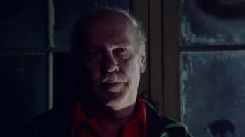 Movie still from “The Hills Have Eyes” (1977), directed by Wes Craven – An older man with a mustache is looking at the camera; Close Up shot, Low angle