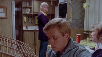 Movie still from “The Hills Have Eyes” (1977), directed by Wes Craven – A man and a woman standing in a kitchen; Medium shot, High angle