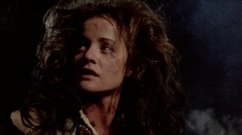 Movie still from “The Hills Have Eyes” (1977), directed by Wes Craven – A person with long curly hair; Close Up shot, Low angle