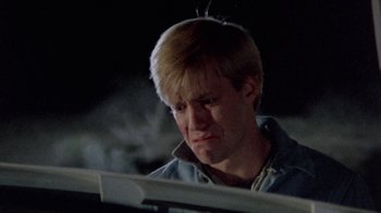 Movie still from “The Hills Have Eyes” (1977), directed by Wes Craven – A man with blonde hair is looking sad; Close Up shot, Low angle
