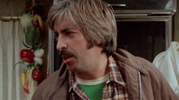 Movie still from “The Hills Have Eyes” (1977), directed by Wes Craven – A person wearing a jacket; Close Up shot, Over the shoulder angle