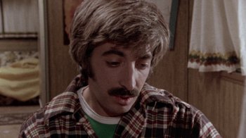 Movie still from “The Hills Have Eyes” (1977), directed by Wes Craven – A person with a mustache; Close Up shot, High angle