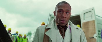 Movie still from “The Hitchhiker's Guide to the Galaxy” (2005), directed by Garth Jennings – A person wearing a jacket; Close Up shot, Low angle